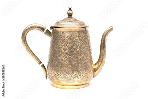 An antique silver teapot on a white background.