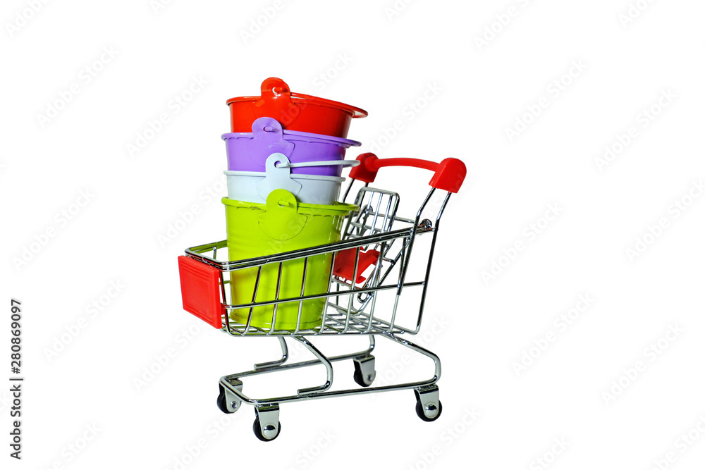 Red, purple, white and light green buckets staked in mini shopping cart isolate on white background at the middle of the frame.