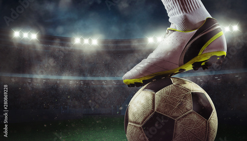 Fototapeta Naklejka Na Ścianę i Meble -  Close up of a soccer striker ready to kicks the ball at the stadium