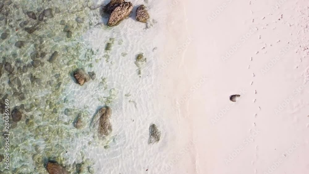 Aerial view of sunshine tropical sand beach, ocean texture, sea waves slow motion, (Video from drone) Aerial view of sunshine tropical sand beach, ocean texture, sea waves slow motion, (Video from drone)