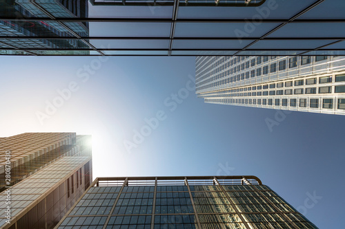 Modern city building architecture with glass fronts on a clear day in London, England at sunrise