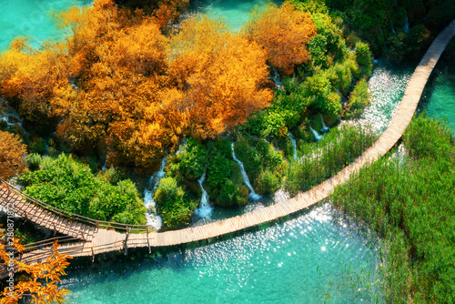 Beautiful wooden path trail for nature trekking with lakes and waterfall landscape in Plitvice Lakes National Park, UNESCO natural world heritage and famous travel destination of Croatia. photo