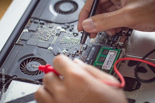 Plakat Professional engineer man fixing hardware computer board.