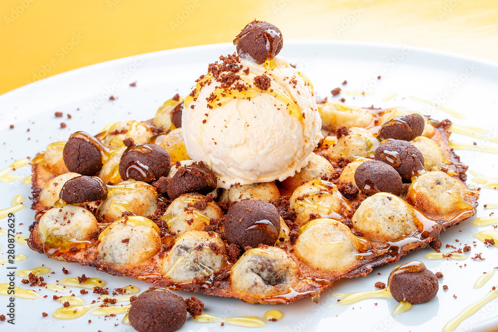 Bubble waffles with ice cream and chocolate chip cookies. On white background Bubble waffles with ice cream and chocolate chip cookies. On white background