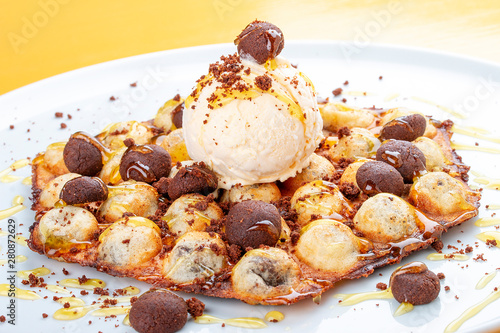 Bubble waffles with ice cream and chocolate chip cookies. On white background