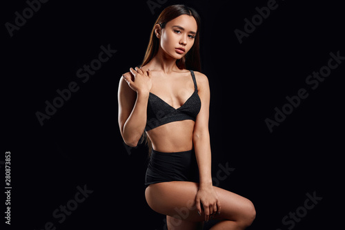 cool sensual woman demonstrating stylish black trendy underwear. close up photo. fashion concept