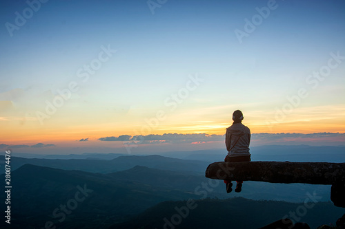 The tourists sit and watch the sunset at Phu Bak Dai on October 27,2018 in Loei,Thailand.