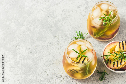 Cold brew grilled nectarines rosemary iced tea. Top view, space for text.