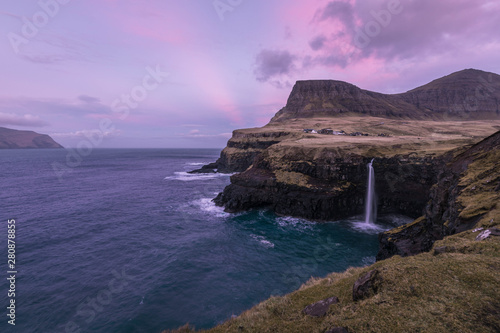 Purple light rays during sunrise at Gasadalur - Faroe Islands - Winter