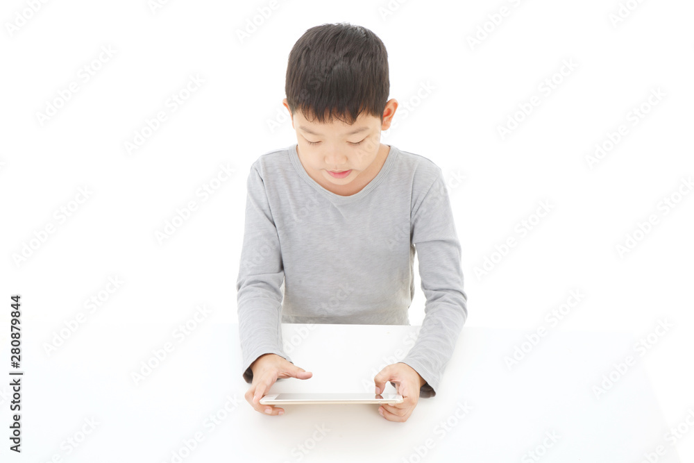 Asian boy using tablet computer isolated on white background. Asian boy using tablet computer isolated on white background.