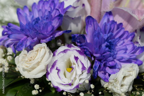 Festive mini bouquet of rose and eustoma flowers and asters in b