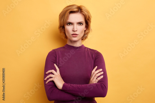 Angry annoyed youngwoman keeping arms crossed and staring at camera with sceptical and distrustful look Human facial expressions. close up portrait