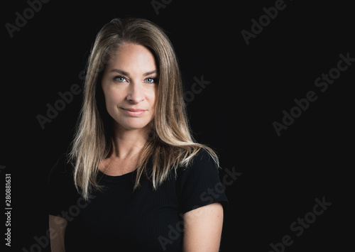 Beautiful middle aged woman on black background with space for text