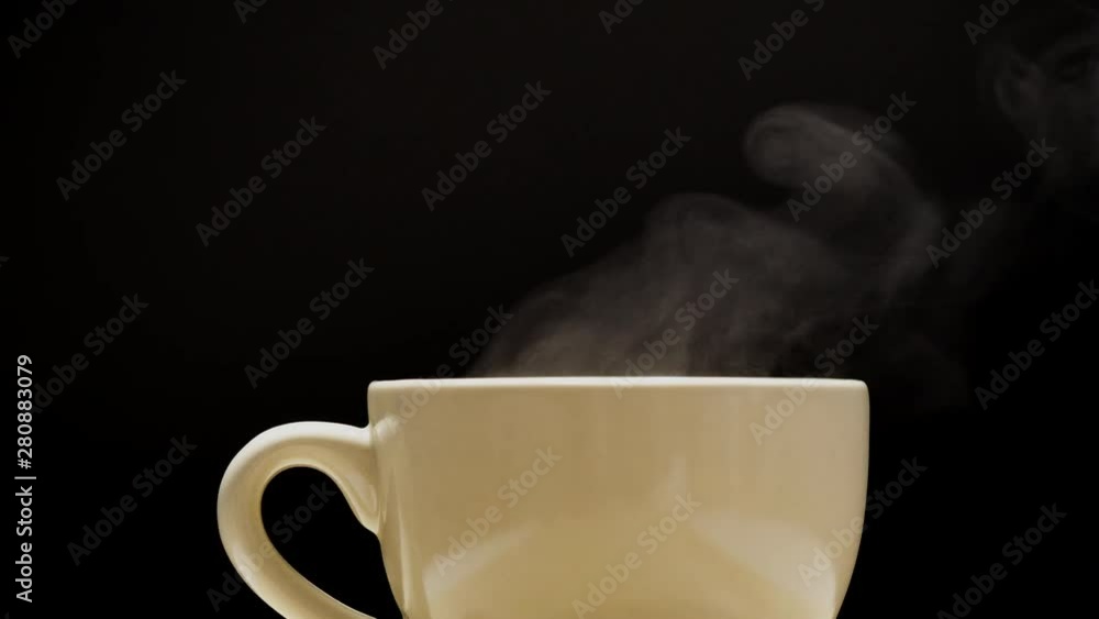 Hot drink with steam from a mug on black background Hot drink with steam from a mug on black background