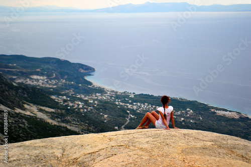 Girl on a big stone. Llogara pass in Llogara National Park, Albania. photo