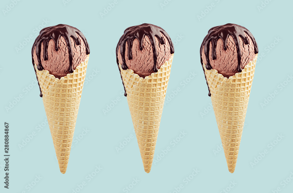 Set of three brown ice cream in crisp waffle cones with chocolate sauce on pastel green background, mock up. Set of three brown ice cream in crisp waffle cones with chocolate sauce on pastel green background, mock up.