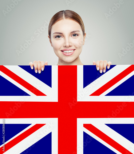 Portrait of happy pretty girl with UK flag background. Young wom