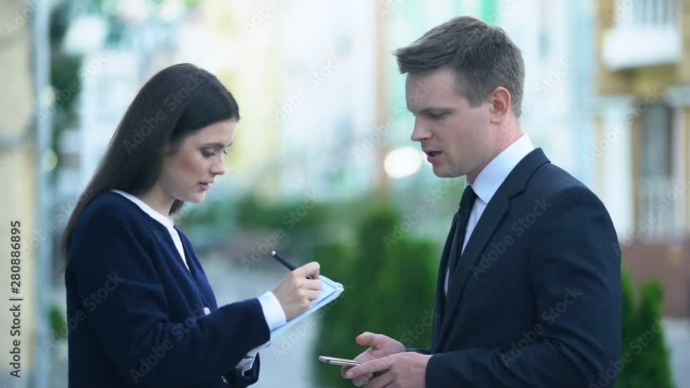Female secretary recording in notebook male boss orders, personal assistant Female secretary recording in notebook male boss orders, personal assistant