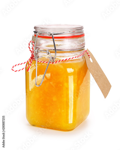Orange marmalade or jam in glass jar with gift tag isolated on white. Contains clipping path.