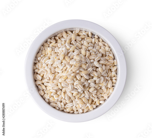 Heap of pearl barley in a bowl isolated on white background. top view