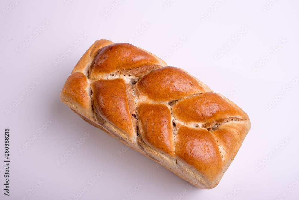 White bread baked from above in the form of a pigtail. Baking on a white background White bread baked from above in the form of a pigtail. Baking on a white background