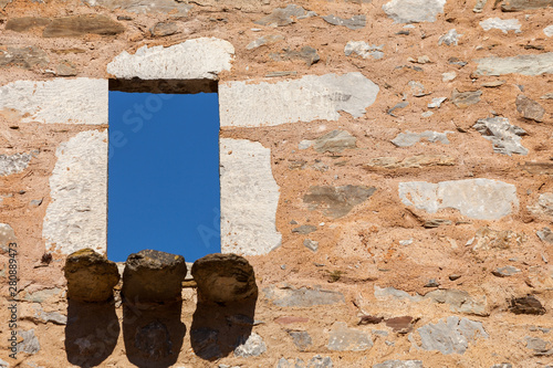 Architecture detail. Old stone wall with window. photo