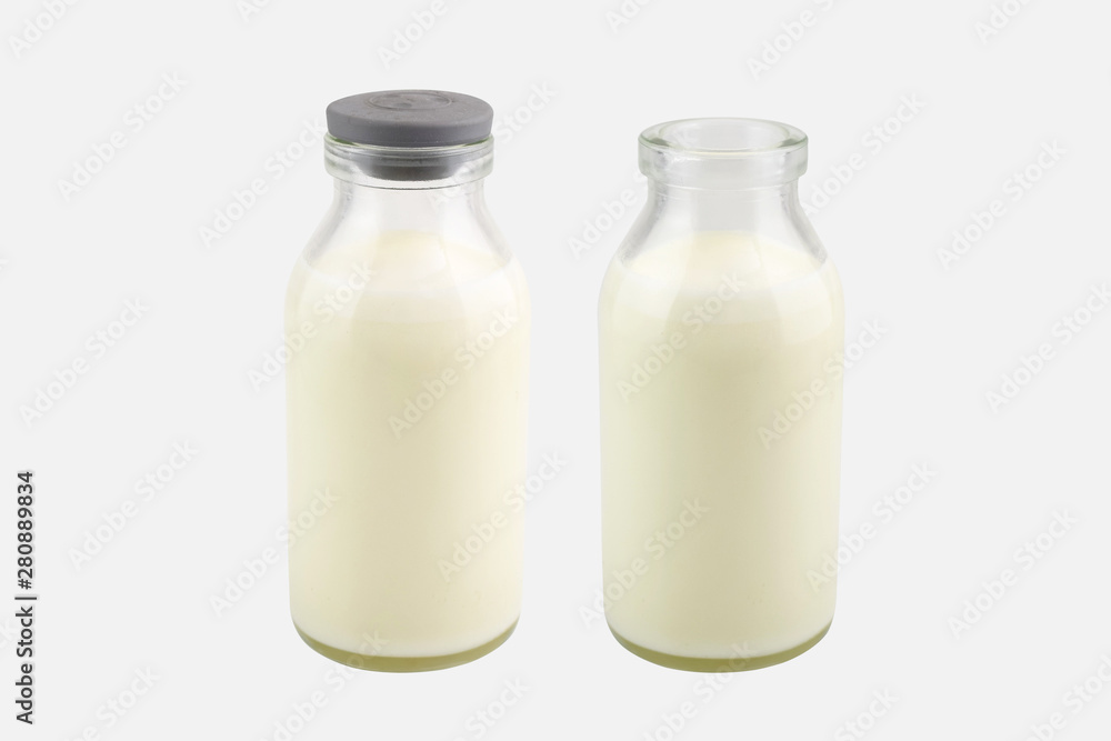 Fresh milk in a transparent bottle with and without lid, isolated on white background, Perspective Fresh milk in a transparent bottle with and without lid, isolated on white background, Perspective