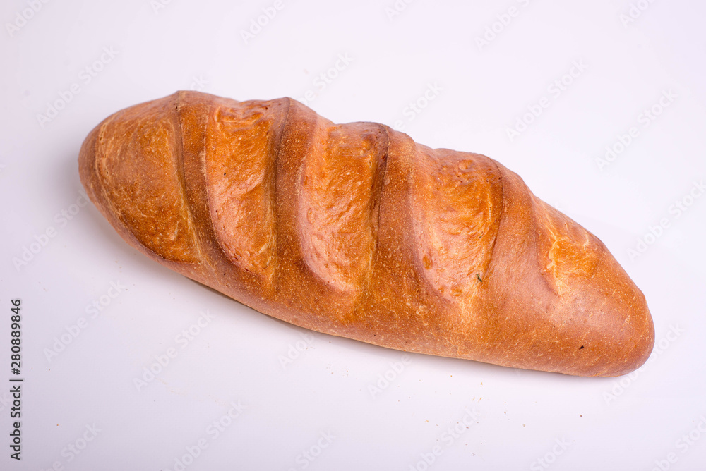 Baked long loaf on white background Baked long loaf on white background