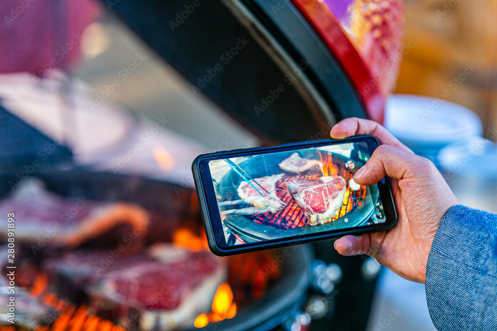 Close up on hand whose take picture of a fresh roasted meat. Close up on hand whose take picture of a fresh roasted meat.