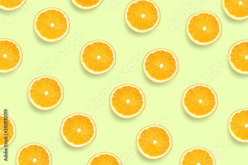 Colorful fruit pattern of fresh orange slices on colored background. Orange slices top view.