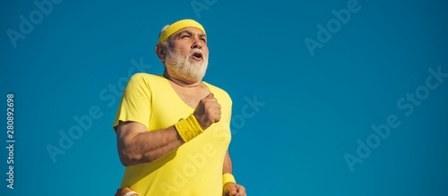 Healthcare cheerful lifestyle. Funny sporty old sportsman finished his work out. Senior man workout in rehabilitation center. Elderly man jogging.