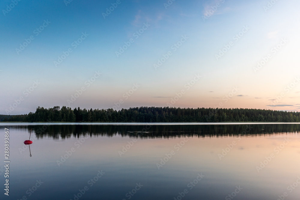 Reflections on the calm waters of the Saimaa lake in Finland at Sunset - 4 Reflections on the calm waters of the Saimaa lake in Finland at Sunset - 4