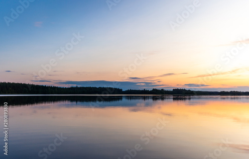 Fototapeta Naklejka Na Ścianę i Meble -  Reflections on the calm waters of the Saimaa lake in Finland at Sunset  - 3