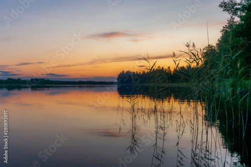 Fototapeta Naklejka Na Ścianę i Meble -  Reflections on the calm waters of the Saimaa lake in Finland at Sunset  - 5