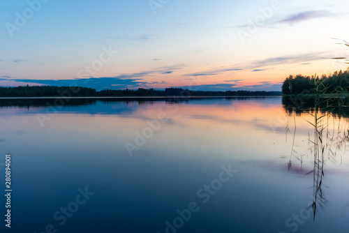 Reflections on the calm waters of the Saimaa lake in Finland at Sunset  - 10