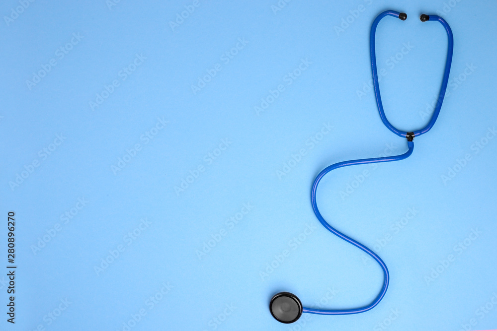 Global healthcare concept.Close-up of stethoscope on a blue background. Listen to the heart with stethoscope. Copy space for text . Flat lay Global healthcare concept.Close-up of stethoscope on a blue background. Listen to the heart with stethoscope. Copy space for text . Flat lay