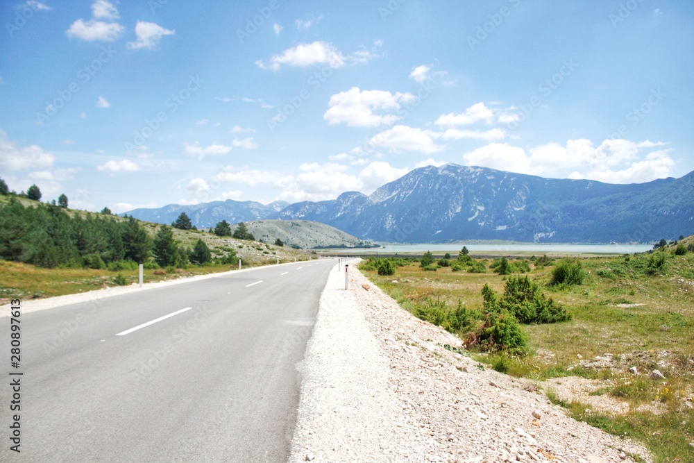 Road in nature to beautiful mountain lake in a natural park