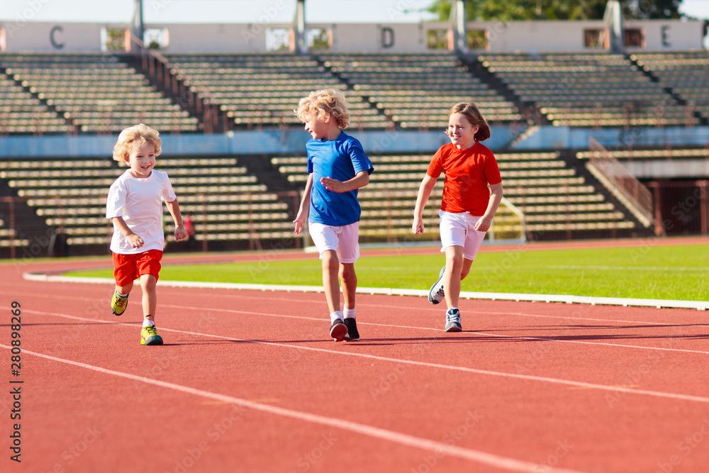Obraz premium Child running in stadium. Kids run. Healthy sport.