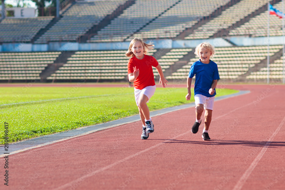 Obraz premium Child running in stadium. Kids run. Healthy sport.