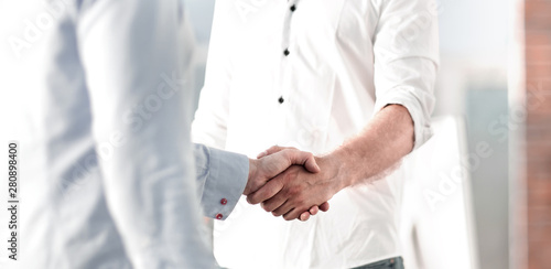 handshake of business people standing in a creative office