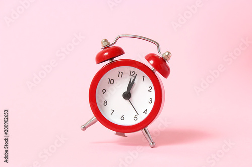 mechanical alarm clock on a colored background