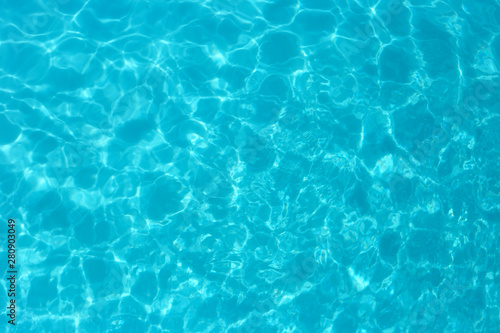 Blue color water in swimming pool rippled water detail background. © prasong.