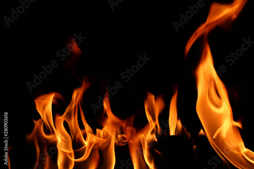Flame on a wooden pile on a black background.