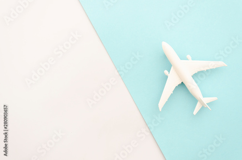 Top view model plane. White airplane on pastel color background. Flat lay design with copy space for horizontal travel banner