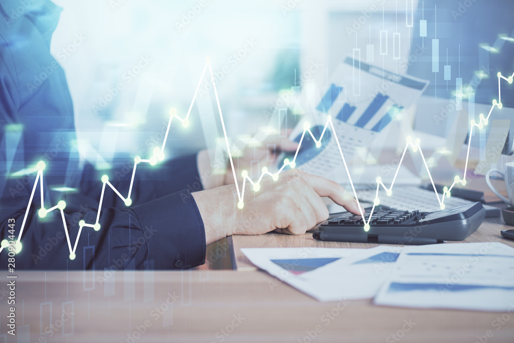 Double exposure of graph with man typing on computer in office on background. Concept of hard work. Closeup. Double exposure of graph with man typing on computer in office on background. Concept of hard work. Closeup.