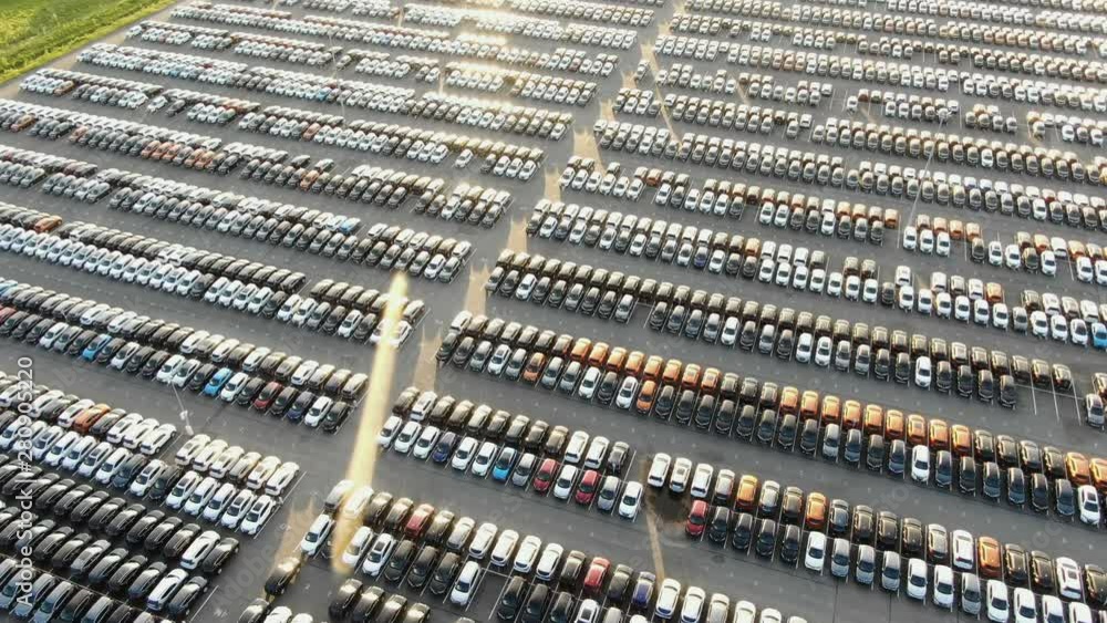 vehicles parked on production plant parking lot at sunset vehicles parked on production plant parking lot at sunset