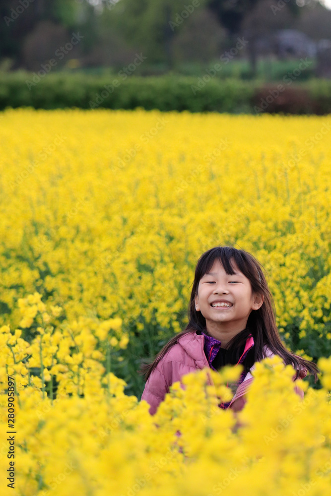 A girl feeling happy and admiring the beauty of canola field A girl feeling happy and admiring the beauty of canola field