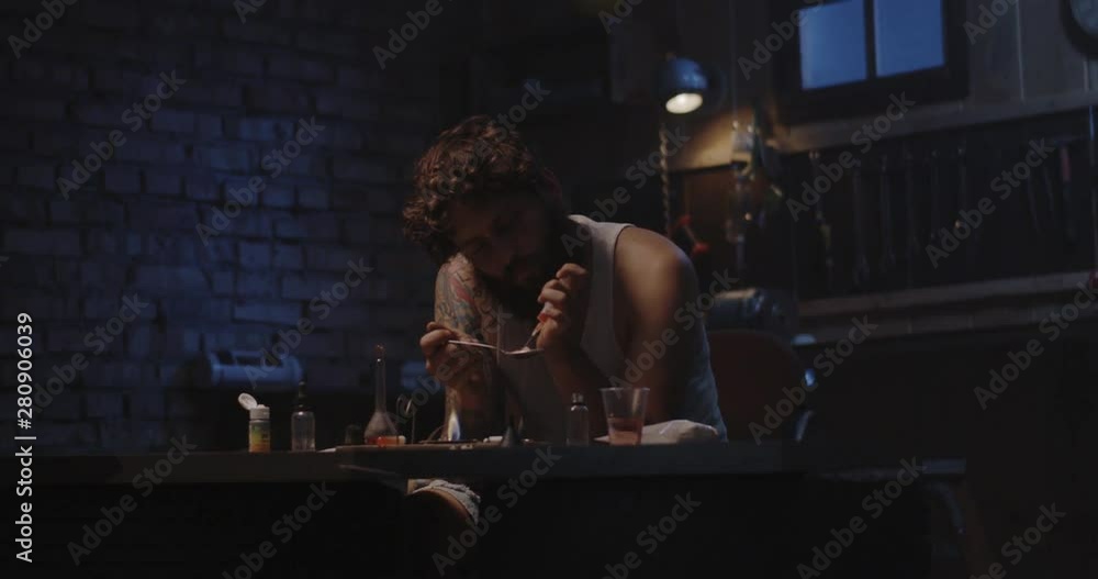 Man heating drug in a spoon Man heating drug in a spoon