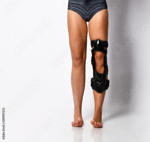 Woman leg with knee brace. Isolated.