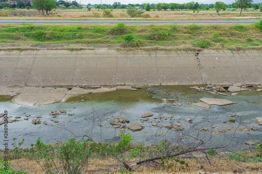 Irrigation canal or irrigation channel in concrete wall Send water from the reservoir to the agricultural area of the farmer that is dry in the rainy season of Thailand. Irrigation canal or irrigation channel in concrete wall Send water from the reservoir to the agricultural area of the farmer that is dry in the rainy season of Thailand.